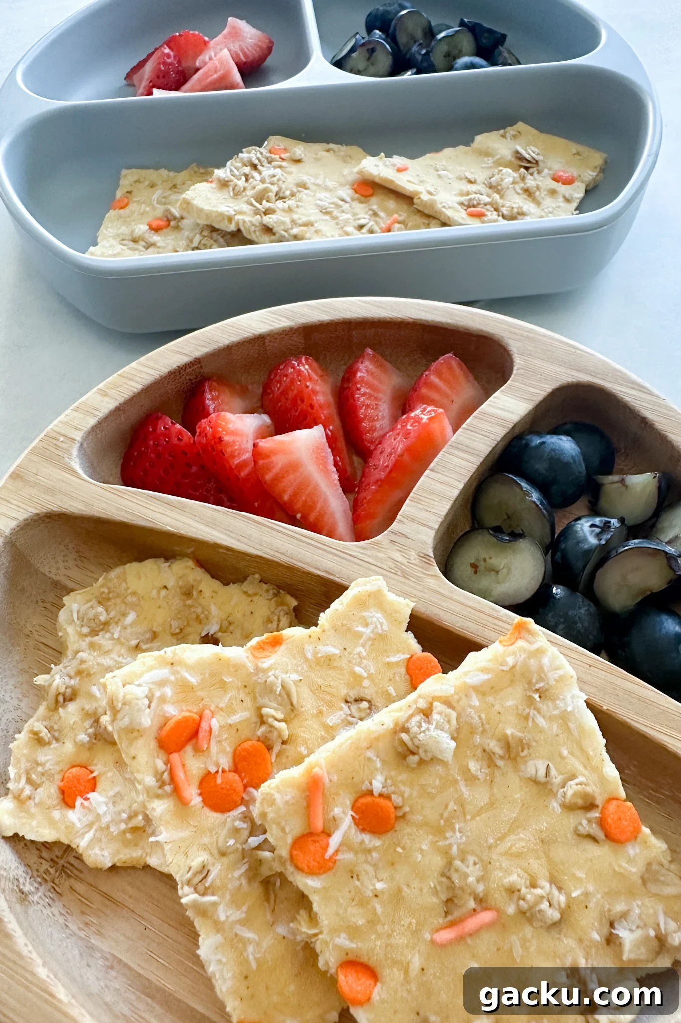 Kid-Friendly Halloween Snack Ideas Kids Will Love 16 Pumpkin yogurt bark served with fruits.