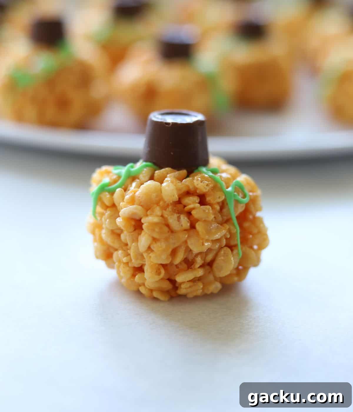 Pumpkin Rice Krispie Treats Recipe for Fall Desserts 2 pumpkin rice krispie treat on white surface