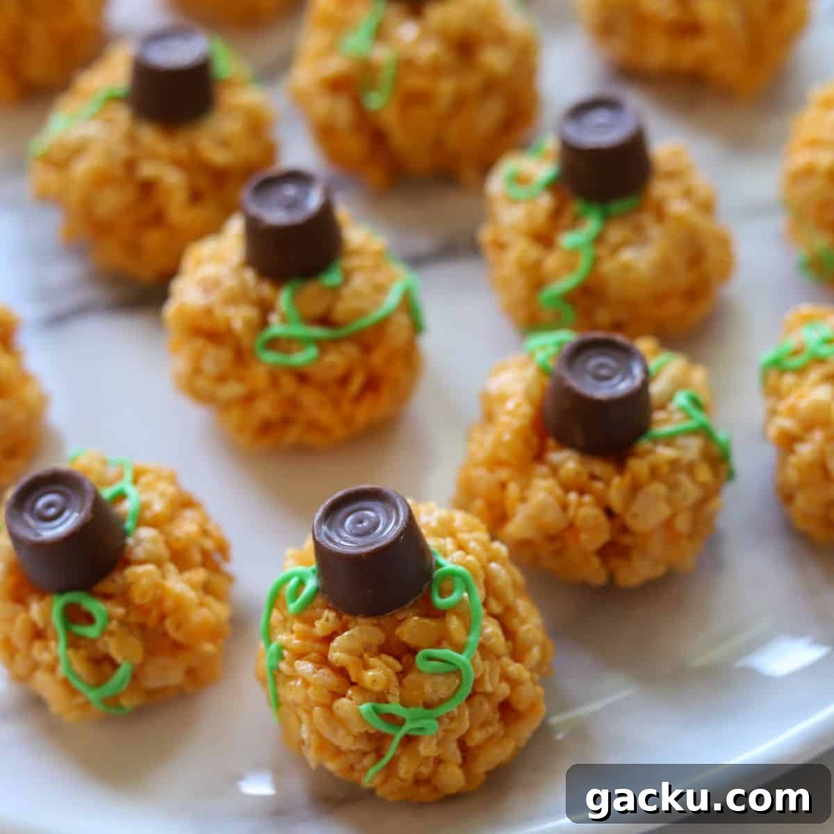 Pumpkin Rice Krispie Treats Recipe for Fall Desserts 3 top view of several decorated pumpkin rice krispie treats