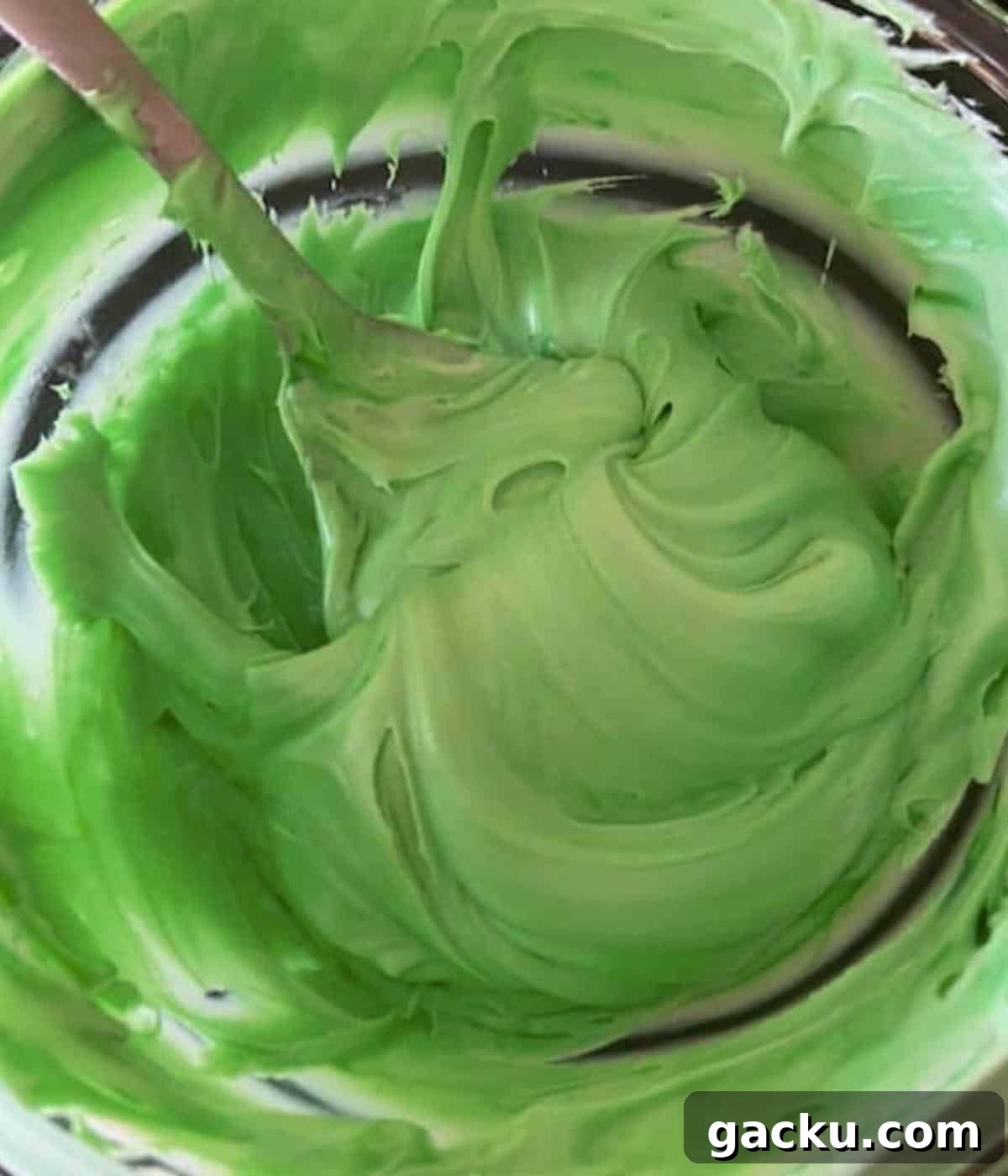 Pumpkin Rice Krispie Treats Recipe for Fall Desserts 7 Green icing in bowl.