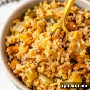 Vegan dirty rice on fork over bowl