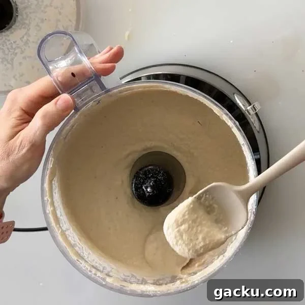 Blending the vegan cheesecake ingredients in a food processor.