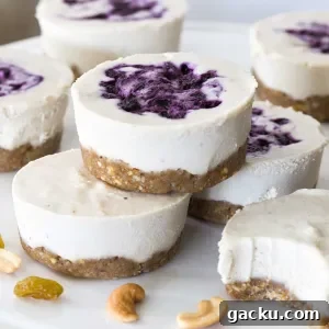 Stack of no-bake vegan cheesecakes with a blueberry filling and cashew crust.