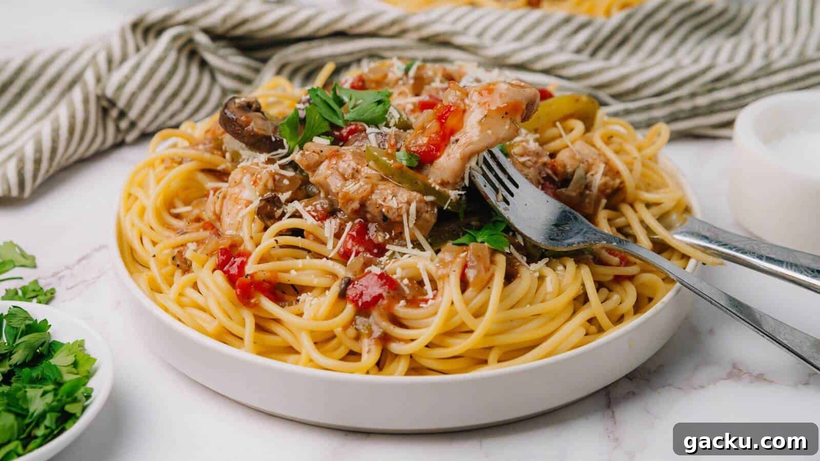 30 One-Pan Skillet Meals for Quick Cleanup and Big Flavor 12 Plate of spaghetti topped with tomato sauce, mushrooms, and herbs, with a fork and spoon on the side.