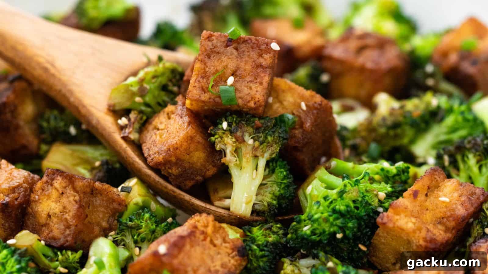30 One-Pan Skillet Meals for Quick Cleanup and Big Flavor 15 Roasted broccoli and tofu cubes garnished with sesame seeds and green onions, served with a wooden spoon.