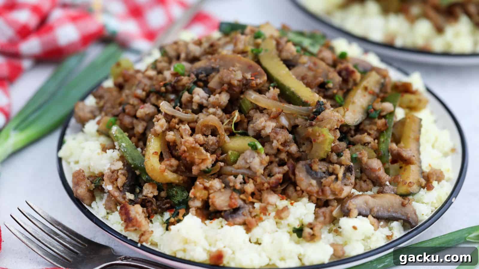30 One-Pan Skillet Meals for Quick Cleanup and Big Flavor 17 A plate with ground pork and vegetables on top of cauliflower rice.