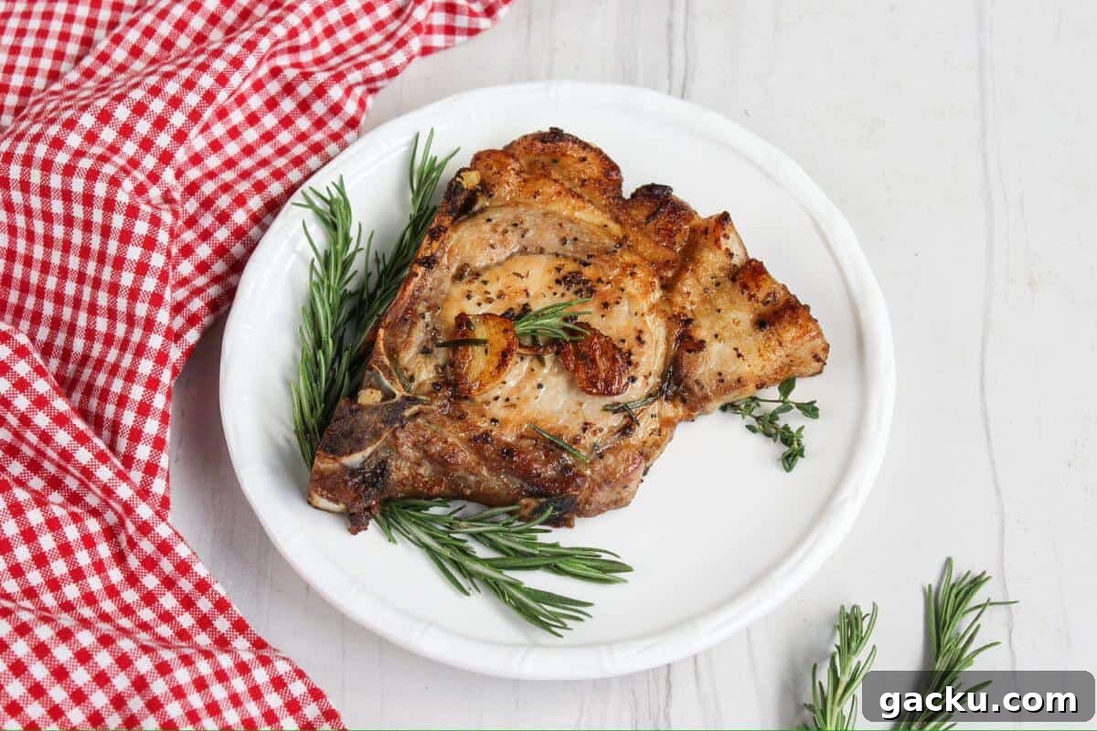 30 One-Pan Skillet Meals for Quick Cleanup and Big Flavor 18 Pork chops on a plate with rosemary sprigs.