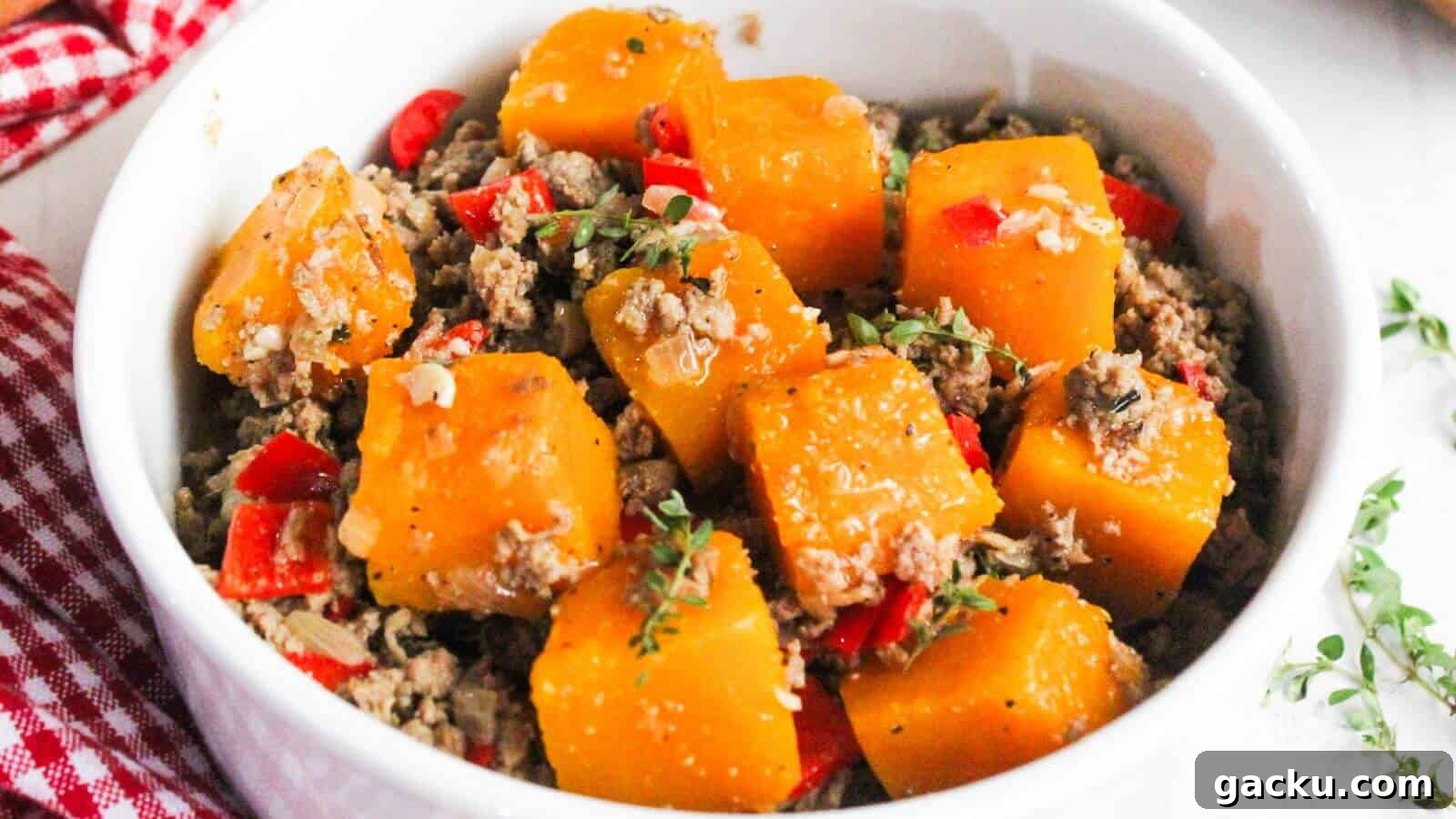 30 One-Pan Skillet Meals for Quick Cleanup and Big Flavor 20 A bowl of cooked butternut squash and ground beef, garnished with herbs and diced red peppers.