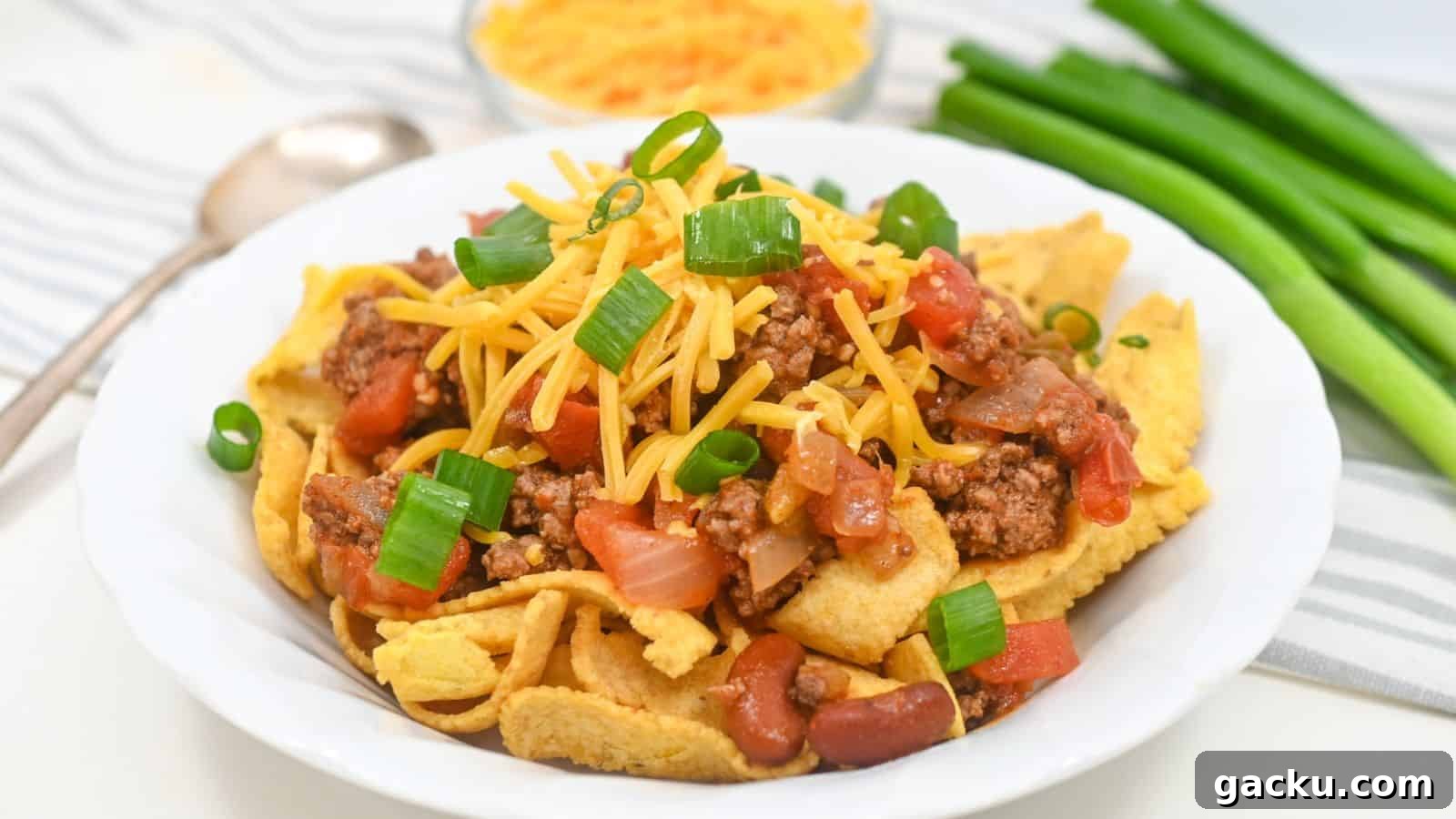 30 One-Pan Skillet Meals for Quick Cleanup and Big Flavor 28 A plate of Fritos topped with ground beef, cheese, tomatoes, beans, and green onions.
