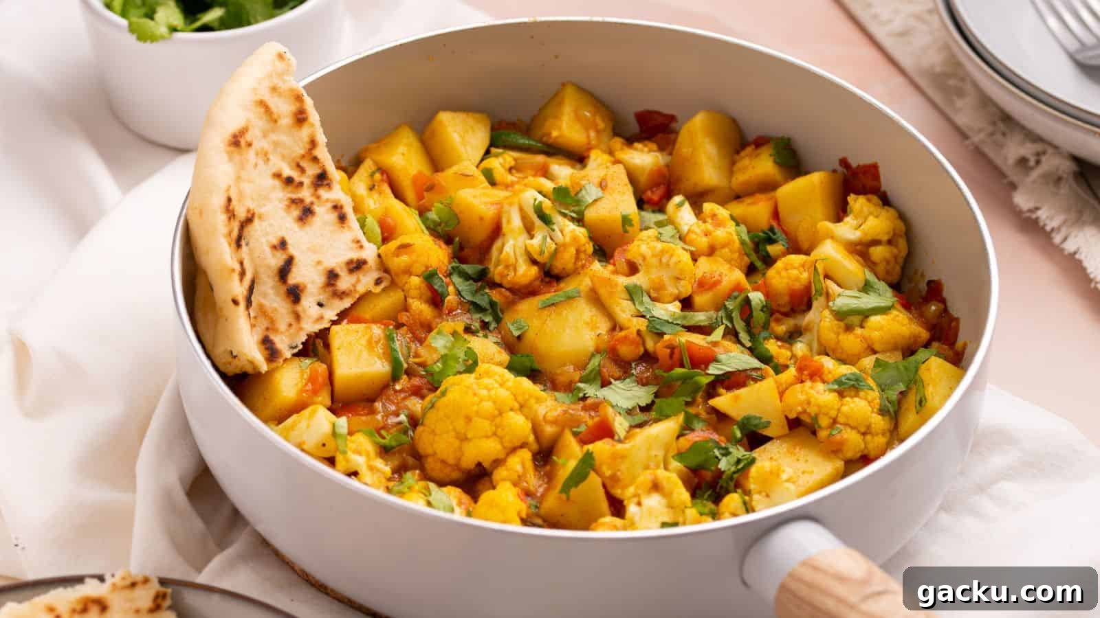 30 One-Pan Skillet Meals for Quick Cleanup and Big Flavor 6 Aloo gobi masala in skillet with naan bread.