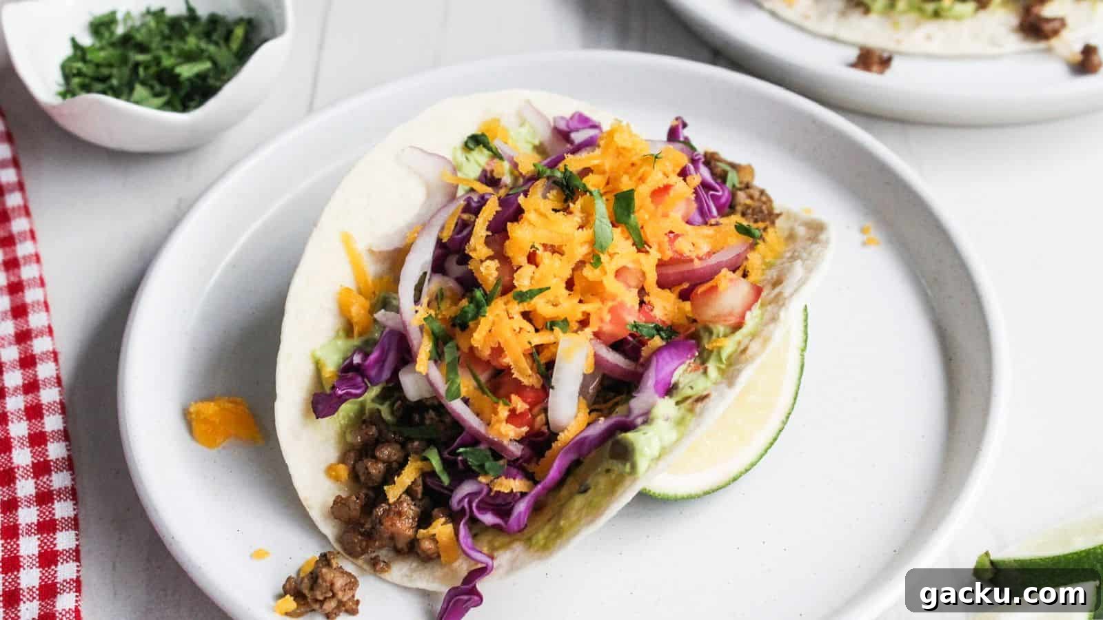 30 One-Pan Skillet Meals for Quick Cleanup and Big Flavor 7 Two pork tacos on a white plate with lime wedges.