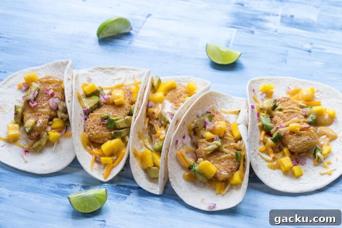 Honey Mustard Fish Tacos with Crispy Slaw and Lime crema 2 Honey Mustard Fish Tacos made with wild caught pollock tenders, onion, mango, avocado, and cheese nestled in a tortilla and drizzled with honey mustard! A tasty dinner on the table in less than 20 minutes.