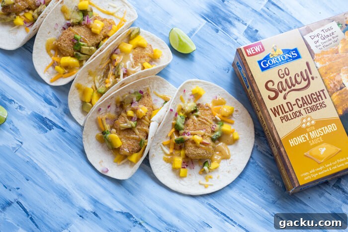 Honey Mustard Fish Tacos with Crispy Slaw and Lime crema 4 Honey Mustard Fish Tacos made with wild caught pollock tenders, onion, mango, avocado, and cheese nestled in a tortilla and drizzled with honey mustard! A tasty dinner on the table in less than 20 minutes.