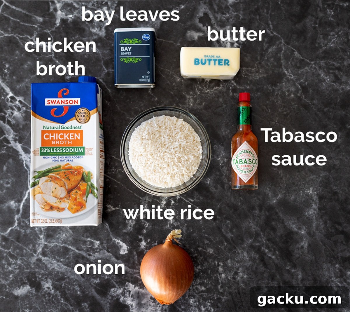 Simple Rice Pilaf Recipe: Fluffy, Flavorful Rice Pilaf in 30 Minutes 4 Chicken broth, rice, bay leaves, butter, tabasco sauce, and an onion on a counter.