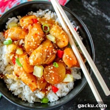 Sweet and sour shrimp in black bowl.