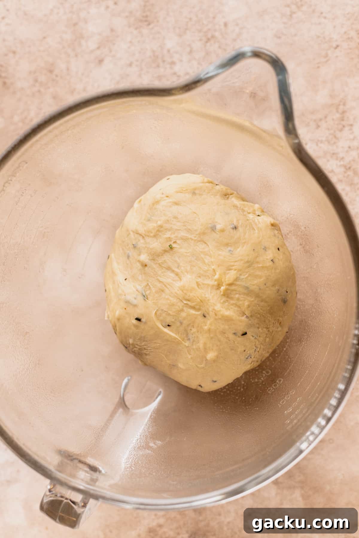 Dough in a glass bowl before rising.