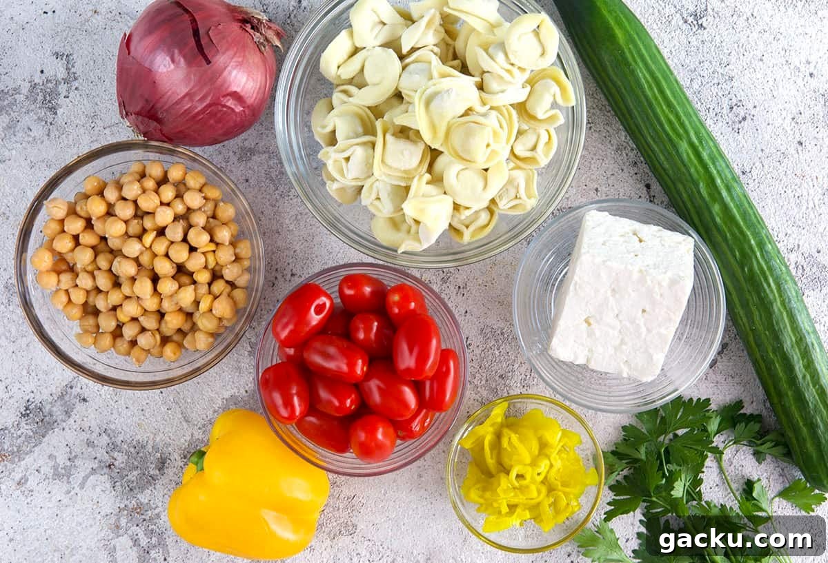 Greek Tortellini Salad with Feta, Olives & Lemon Dressing 4 Greek Tortellini Salad ingredients, chickpeas, tortellini, feta, cucumbers and veggies.