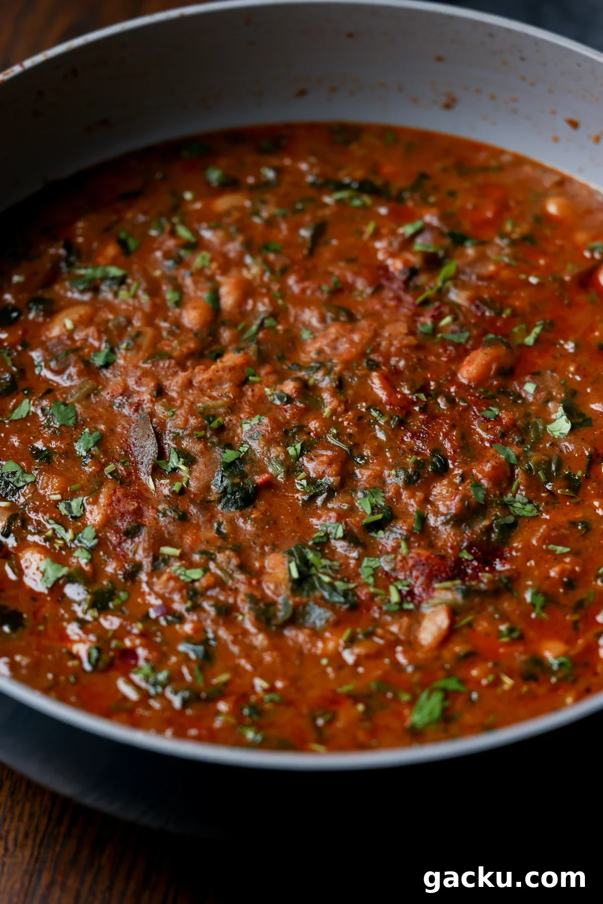close-up of lentil bean stew in the pan after cooking and garnishing