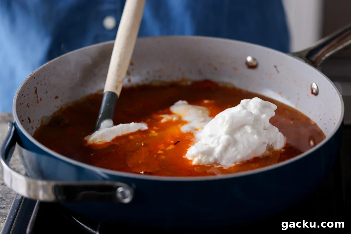 adding coconut milk to the pan