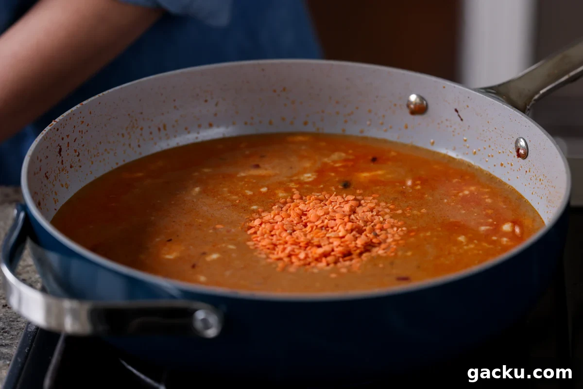 adding lentils to the pan