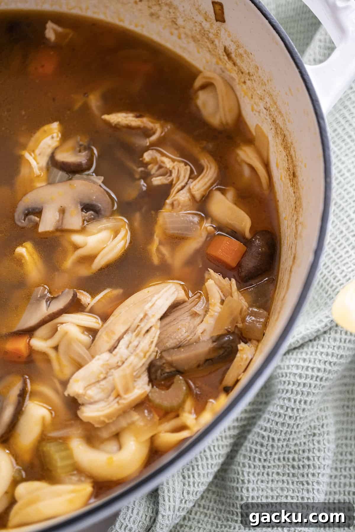 Creamy Chicken Tortellini Soup Recipe for Cozy Weeknights 11 Pot of Chicken tortellini soup with mushrooms.