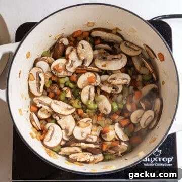 Creamy Chicken Tortellini Soup Recipe for Cozy Weeknights 8 Mushrooms sauteing with the vegetables.