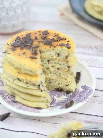 Protein pancakes with chocolate chips stacked on a plate.