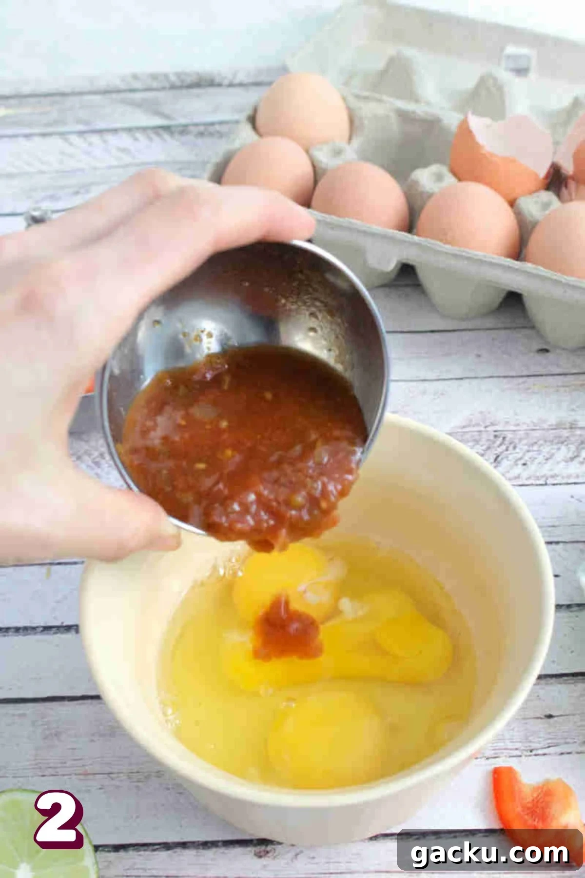 Salsa being poured into a bowl of three eggs.