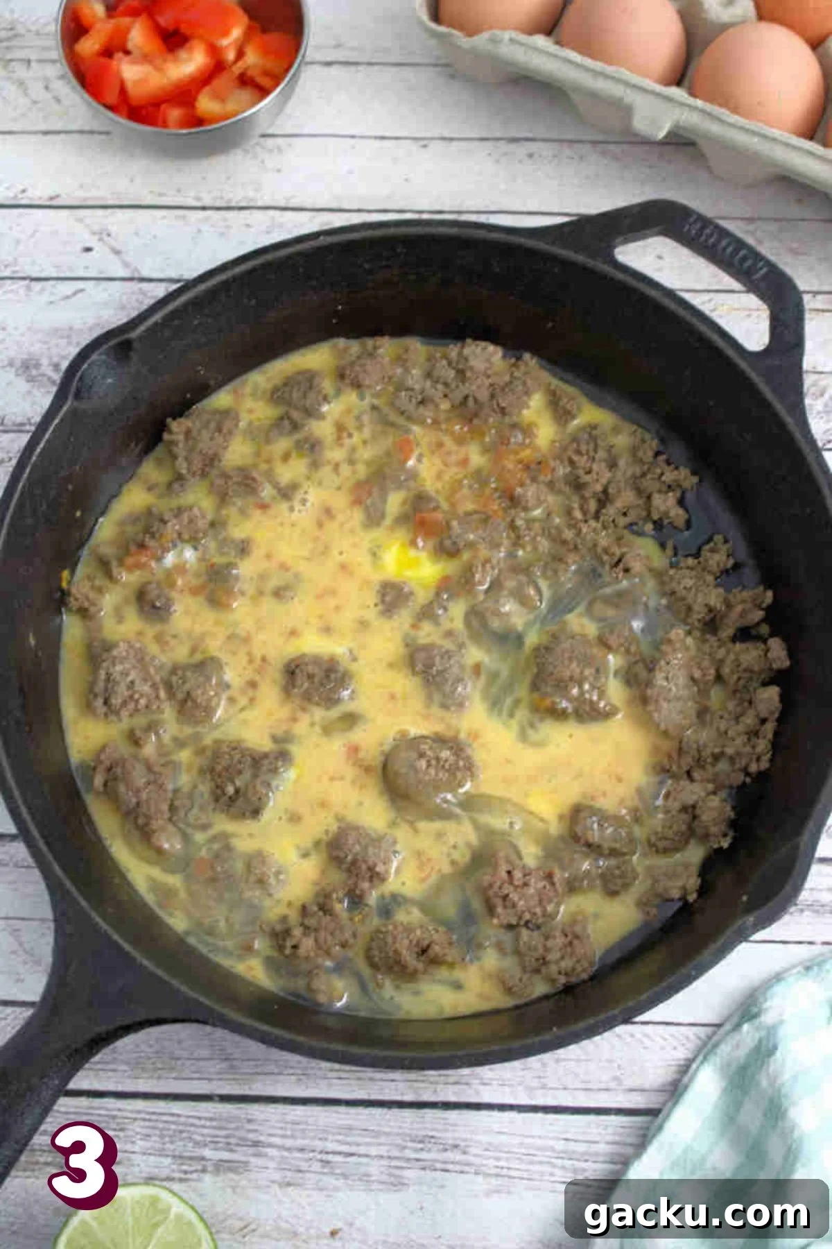 Beef and scrambled eggs in a black skillet