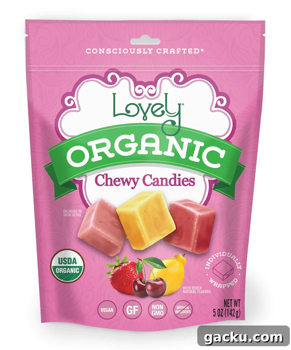 A pink pouch of The Lovely Company's Organic Chewy Candies is displayed, featuring images of three fruit-flavored square candies and fresh fruit.