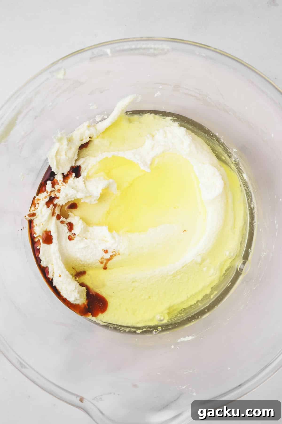 large bowl with egg white and vanilla extract