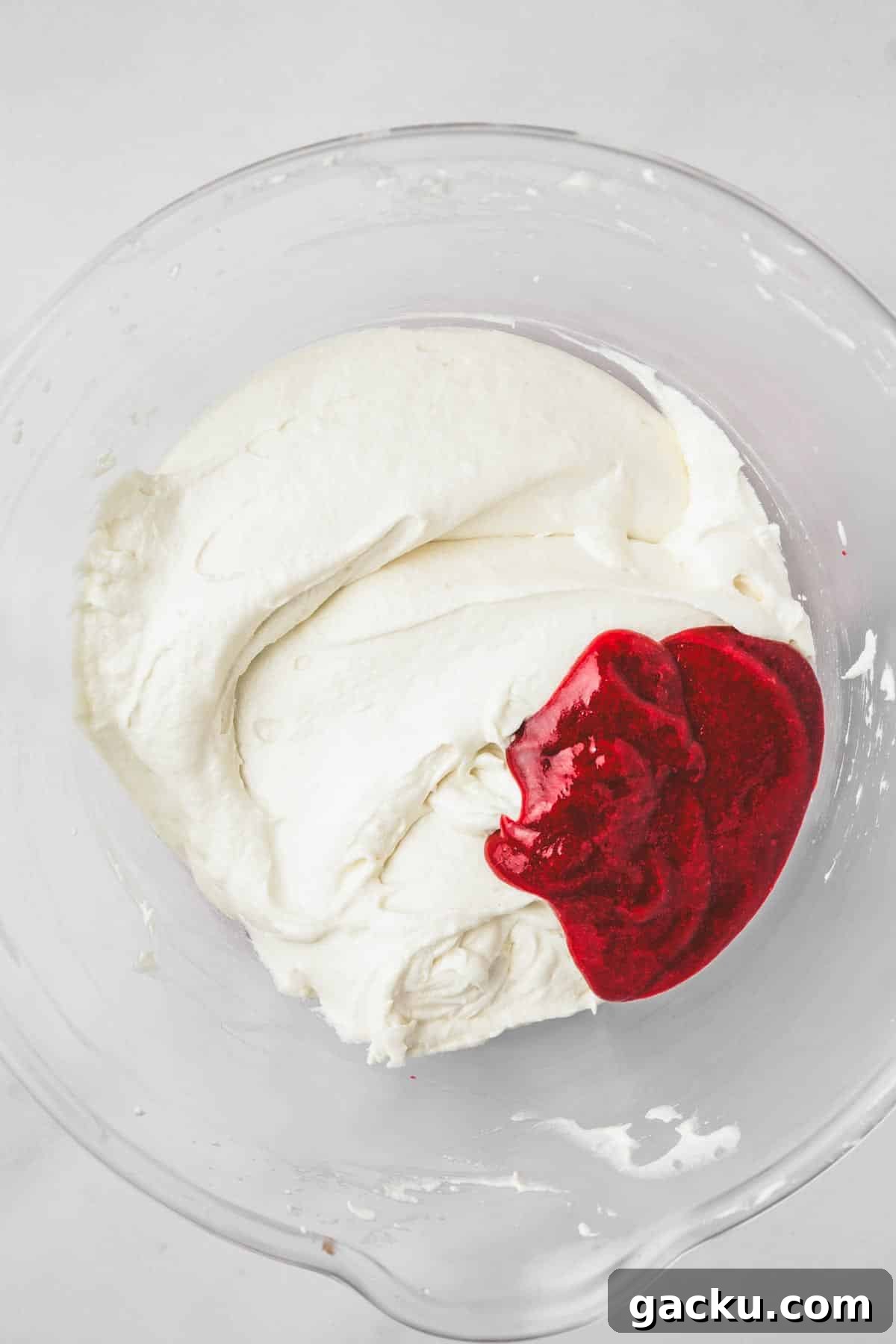 mixing bowl with cake batter and raspberry mixture