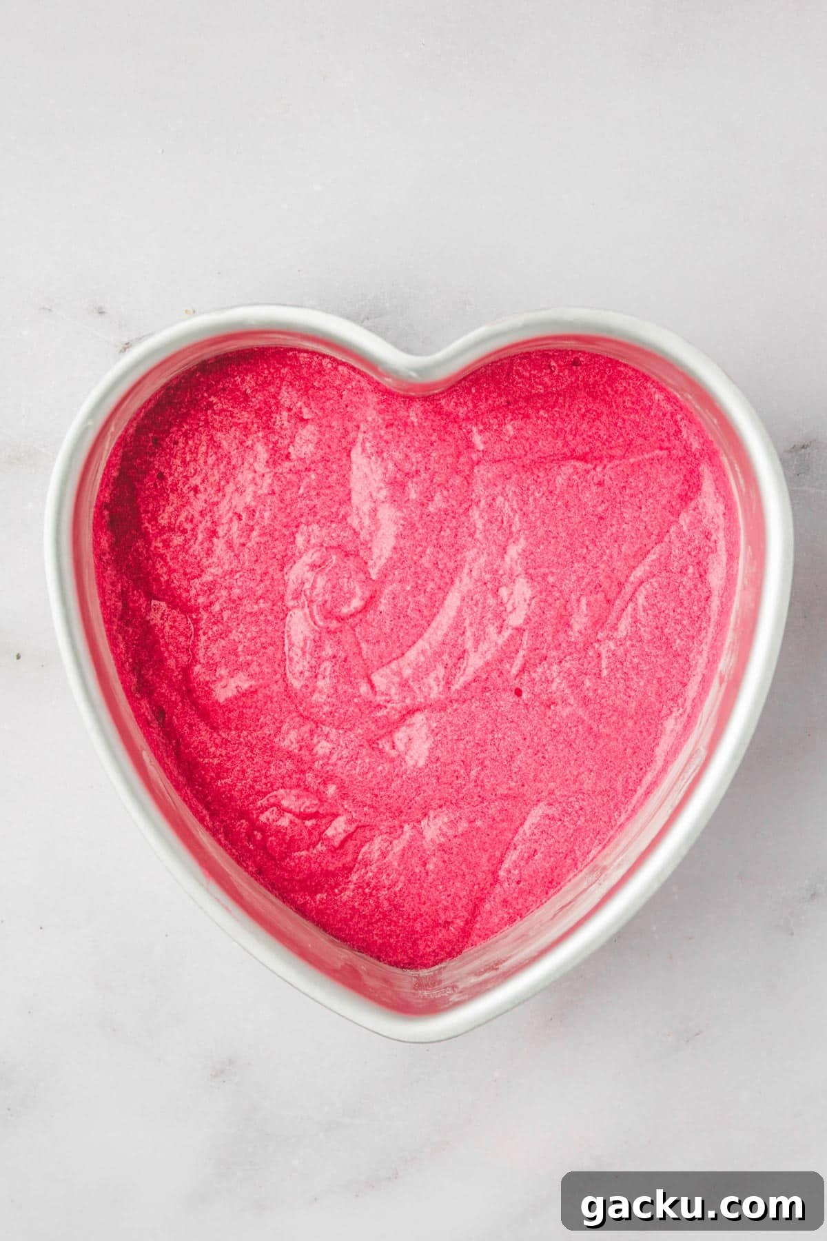 heart shaped cake pan with pink cake batter