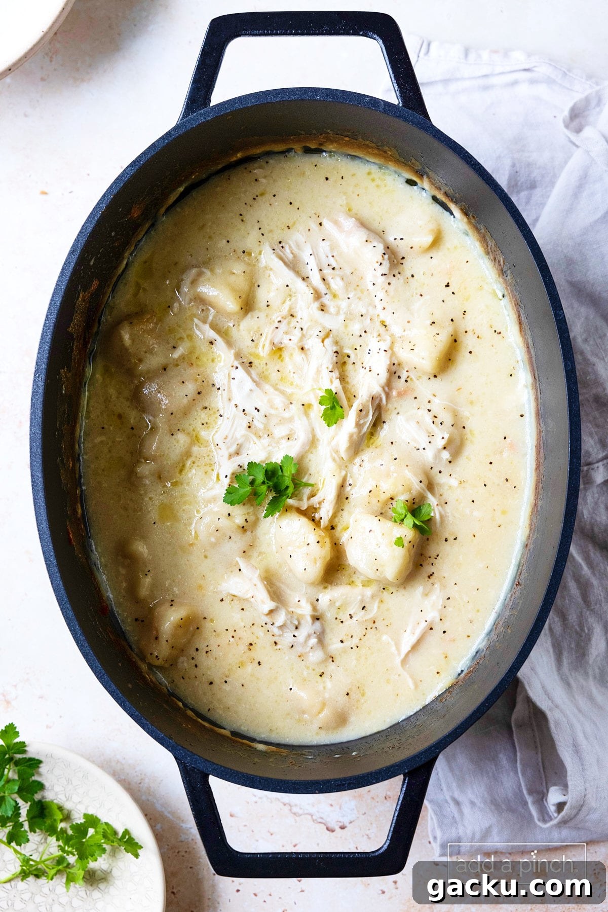 Cooked slow cooker chicken and dumplings ready to serve.