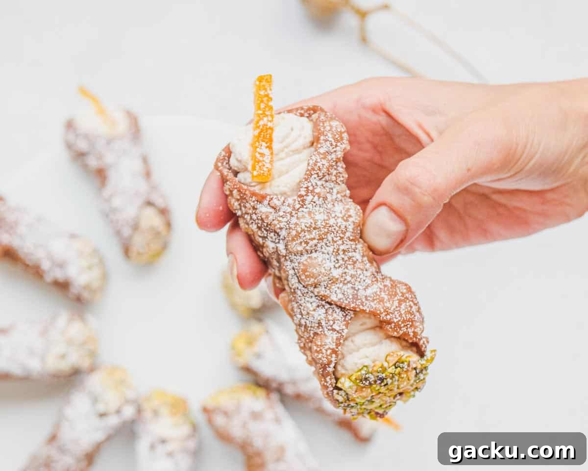 Vegan Cannoli: Crispy Shells with Creamy Ricotta-Style Filling 13 Louise holding a cannolo