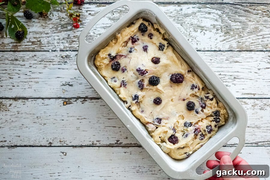 Moist Homemade Blackberry Bread Recipe for Summer Baking 4 A silver loaf pan of blackberry bread batter ready to be baked.