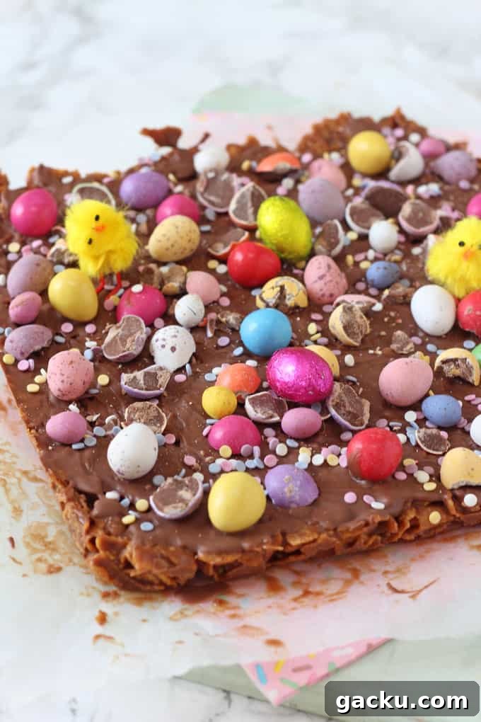 No-Bake Easter Cornflake Crunch: Kid-Friendly Holiday Treat 3 a close up of the Easter Cornflake Crunch Traybake topped with mini eggs
