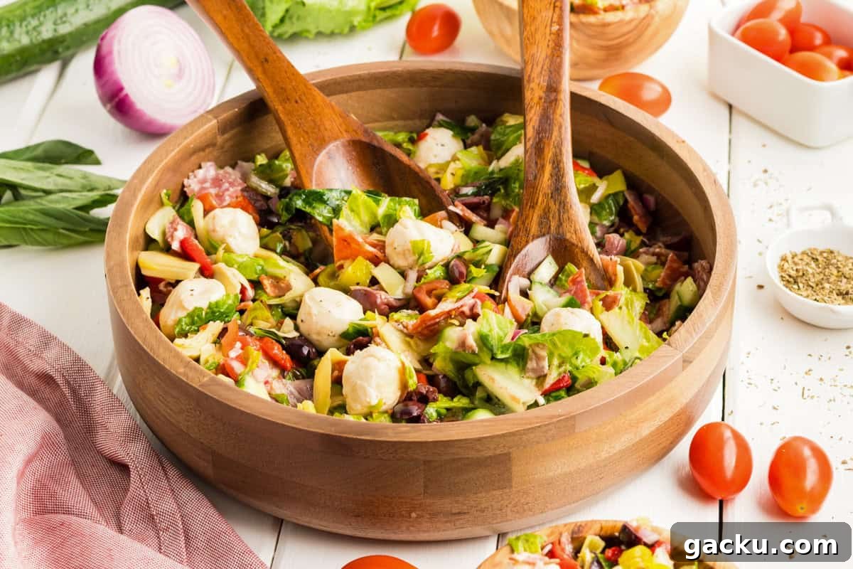 Chopped antipasti salad served in a wooden bowl.