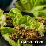 ground chicken lettuce wraps on a black plate