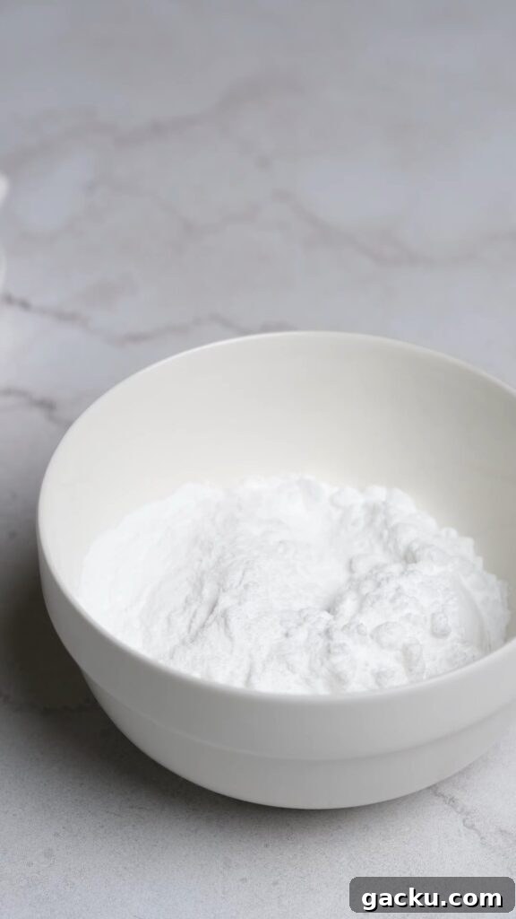 Ultra-Moist Mini Red Velvet Cupcakes for Parties 6 A bowl of powdered sugar and instant clearjel for stabilized whipped cream.