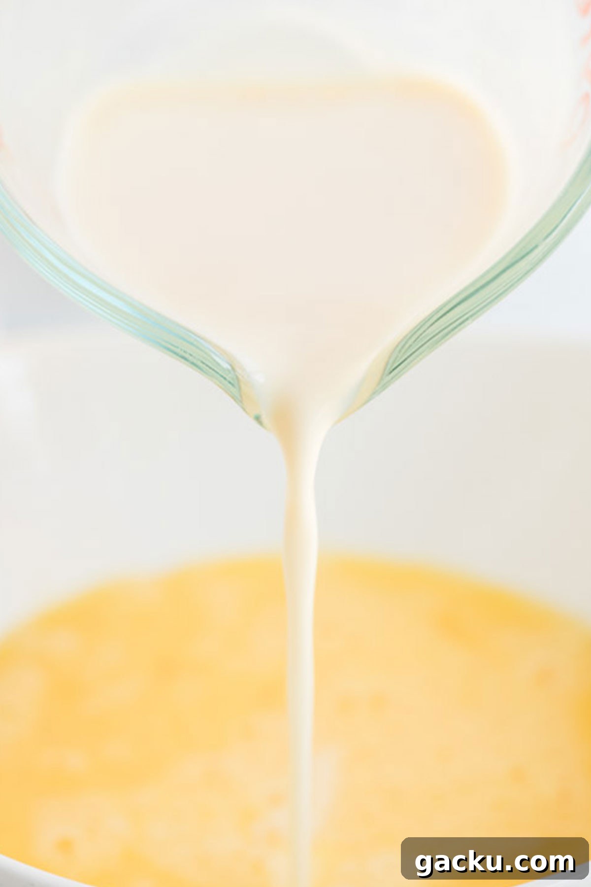 Pouring milk into egg mixture
