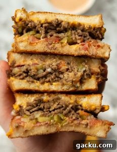 overhead shot of 3 sandwich halves showing filling above marble background