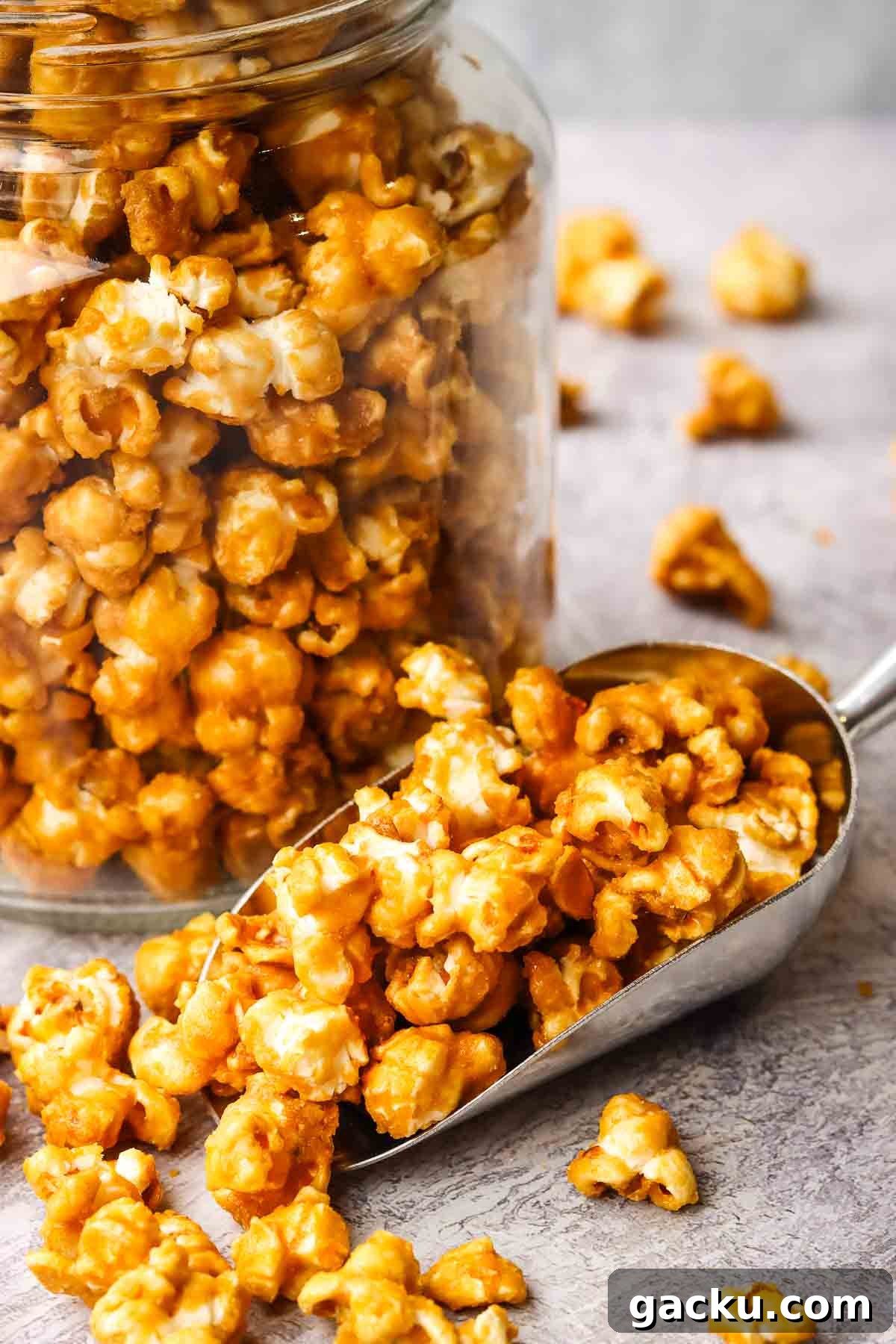 closeup view of caramel corn in a jar and in a popcorn scoop